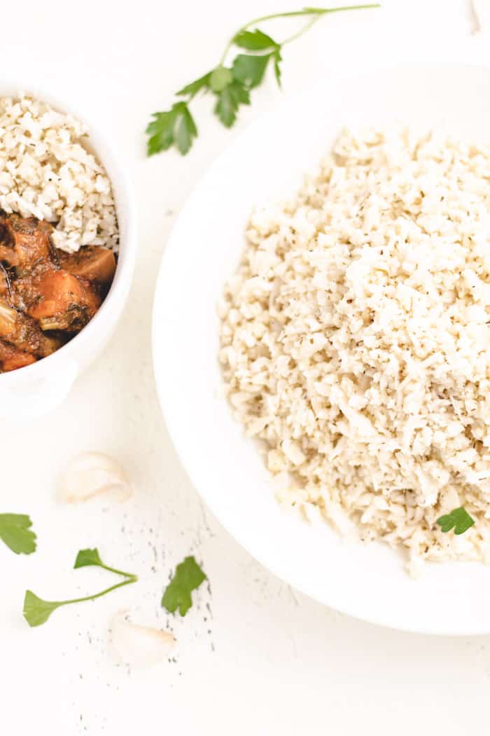 riced cauliflower made with a food processor piled high in a bowl