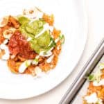 keto tostada plated with shredded chicken, guacamole and salsa