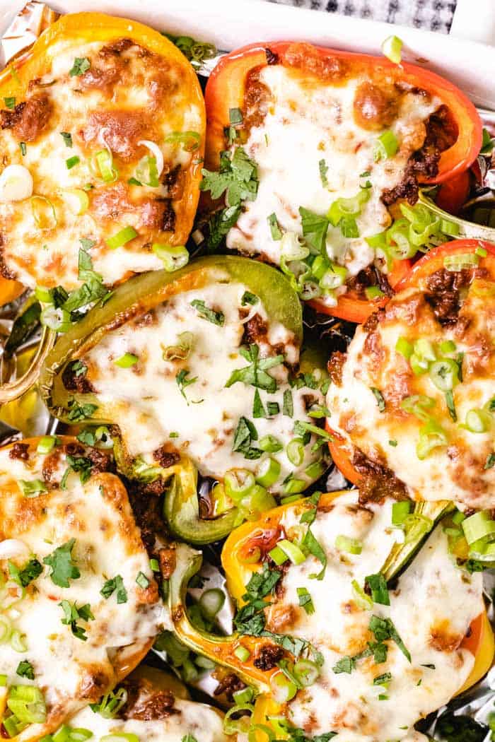 stuffed peppers with filling and cheese in a casserole